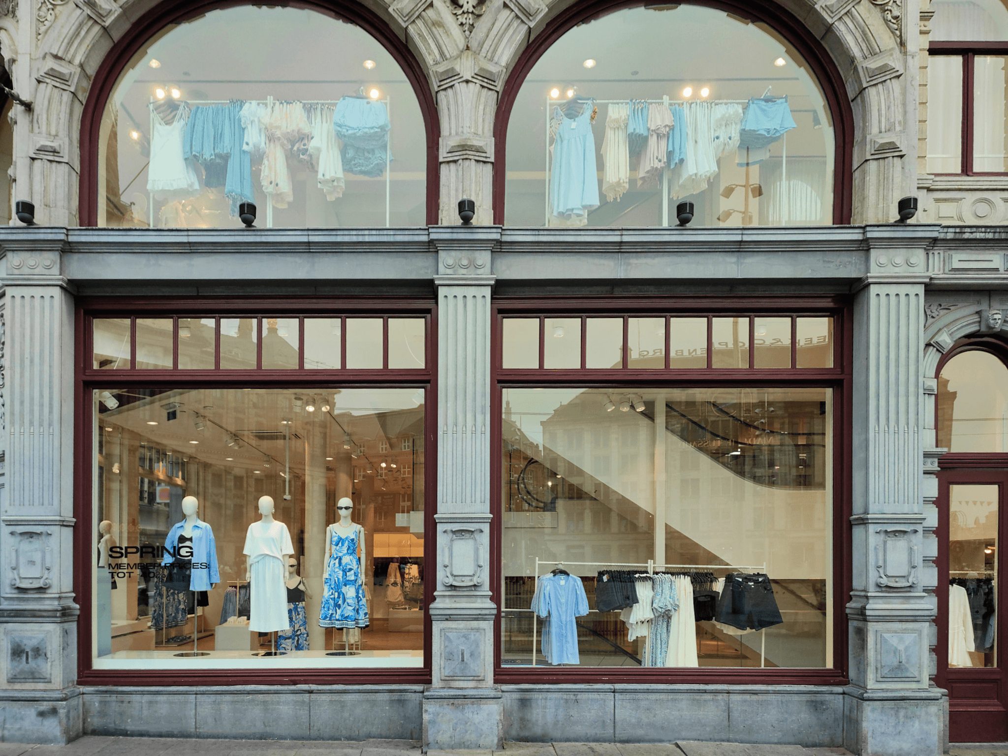 H&M Dam flagship, arched stone façade with spring window mannequins