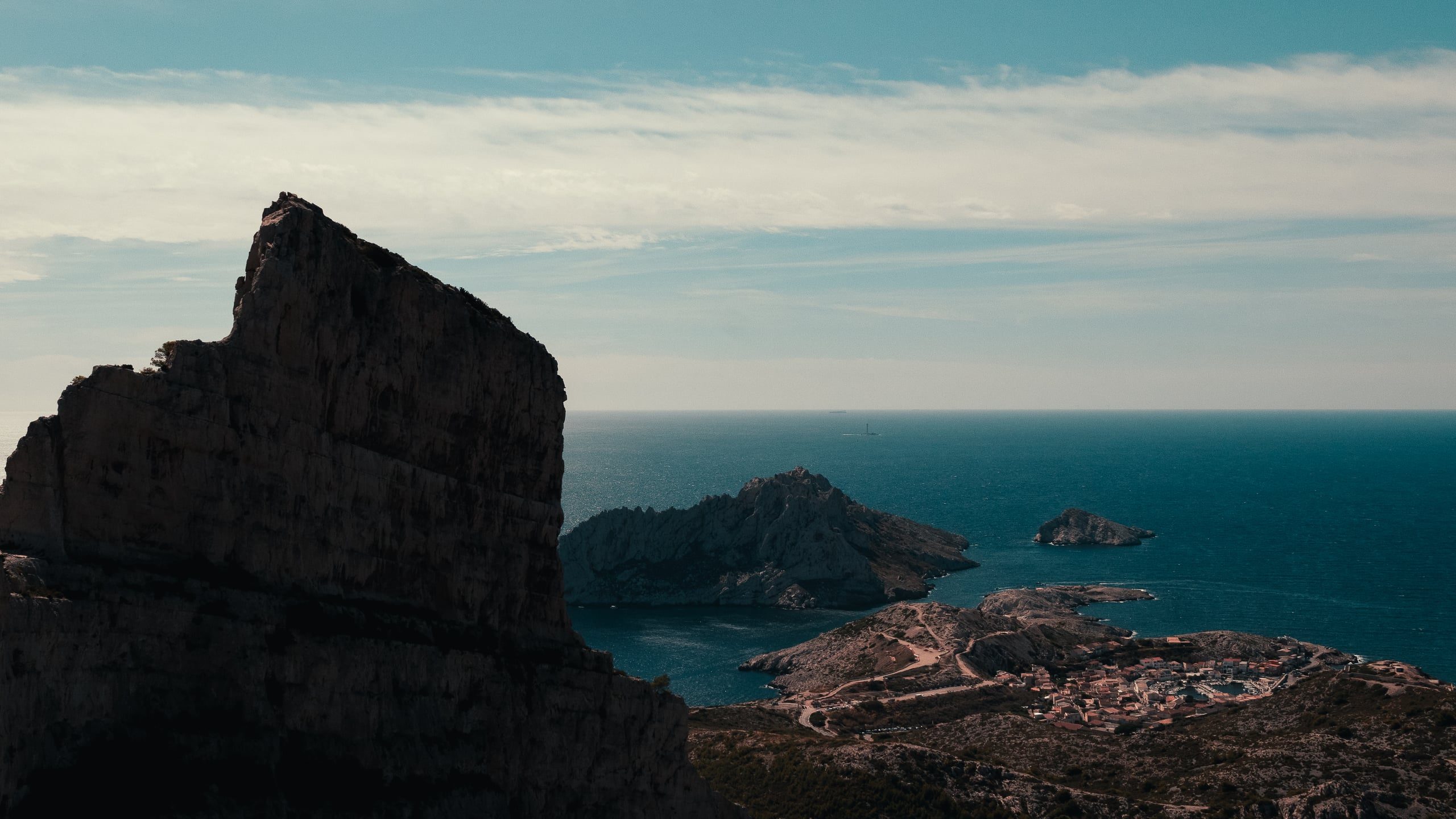 Calanques limestone cliff with Mediterranean and small village below